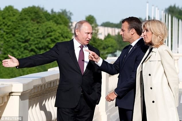 Putin presents Brigitte Macron with flowers as he meets with French president for talks on the Iran, Syria