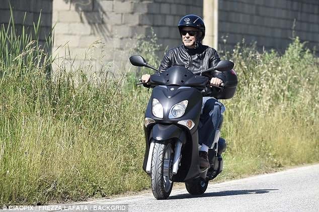 George Clooney enjoys Sardinia as he takes his motorcycle for a spin