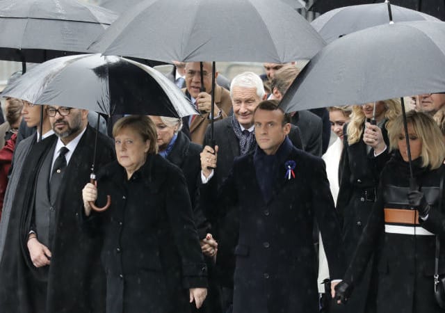 Merkel joins Putin, Trump in sombre Paris ceremony