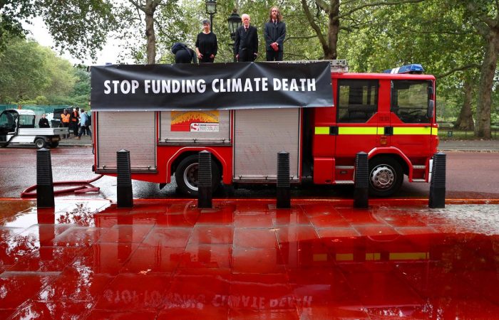 Climate change activists spray red paint at UK Treasury from fire engine